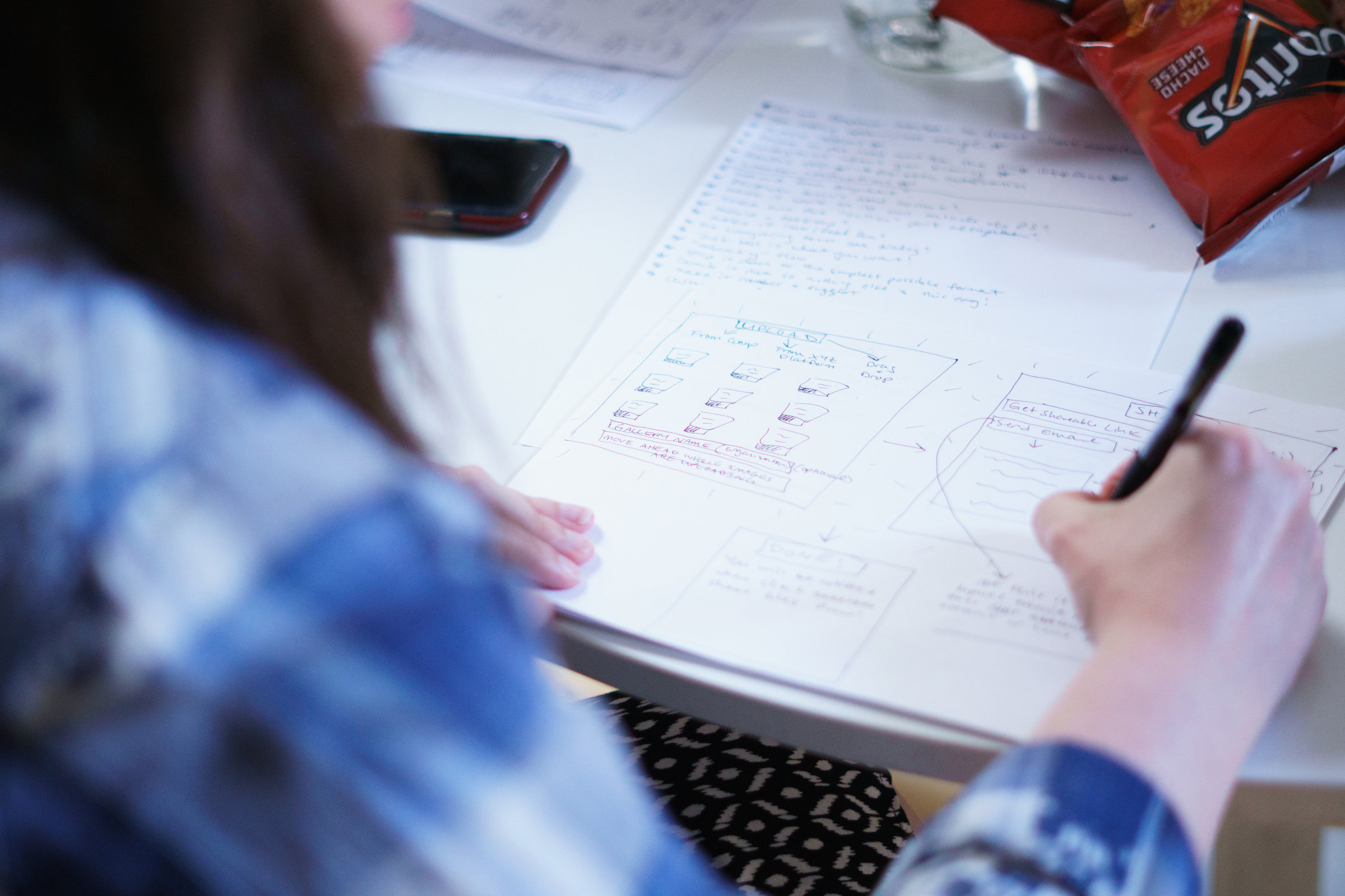 A GV sprint participant sketches a website idea on paper.